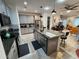 Open concept kitchen island with stainless steel appliances at 5508 Viola Lee Way, Lutz, FL 33558
