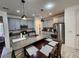 Modern kitchen with gray cabinets, granite countertops, and island at 5508 Viola Lee Way, Lutz, FL 33558