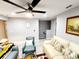 Spacious living room with light walls, plush sofas, and ceiling fan at 5508 Viola Lee Way, Lutz, FL 33558
