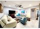 Living area with sectional sofa, accent chair, and a large TV at 5508 Viola Lee Way, Lutz, FL 33558