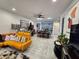 Spacious living room with open floor plan and large TV at 5508 Viola Lee Way, Lutz, FL 33558