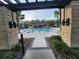 View of the community pool through a pergola at 5508 Viola Lee Way, Lutz, FL 33558