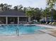 Inviting community pool with plenty of seating and umbrellas at 5508 Viola Lee Way, Lutz, FL 33558