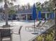 Resort-style pool with seating, umbrellas, and grilling station at 5508 Viola Lee Way, Lutz, FL 33558