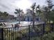 Community pool with lounge chairs, umbrellas, and a covered patio at 5508 Viola Lee Way, Lutz, FL 33558