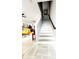 Modern staircase with wood and white risers, connecting the first and second floors at 5508 Viola Lee Way, Lutz, FL 33558