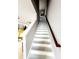 Modern staircase with wood and white risers, connecting the first and second floors at 5508 Viola Lee Way, Lutz, FL 33558