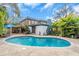 Curving pool with surrounding brick patio at 6095 2Nd S Ave, St Petersburg, FL 33707