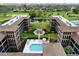 Aerial of condo complex with pool and lush landscaping at 6100 Gulfport S Blvd # 214, Gulfport, FL 33707