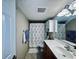 Clean bathroom with shower/tub combo, vanity, and floral shower curtain at 6100 Gulfport S Blvd # 214, Gulfport, FL 33707