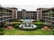 Courtyard view of condo building with pool and seating area at 6100 Gulfport S Blvd # 214, Gulfport, FL 33707
