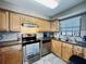Kitchen with light wood cabinets, granite countertops, and stainless steel appliances at 6100 Gulfport S Blvd # 214, Gulfport, FL 33707