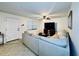 Living room with sectional sofa, large TV, and ceiling fan at 6100 Gulfport S Blvd # 214, Gulfport, FL 33707