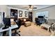 Home office featuring a leather couch, two workstations, and built-in bookshelves at 6100 Gulfport S Blvd # 214, Gulfport, FL 33707