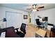Home office with two desks, comfortable seating, and built-in shelving at 6100 Gulfport S Blvd # 214, Gulfport, FL 33707