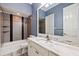 Bathroom with marble countertop, bathtub, and gray tile at 6355 W Maclaurin Dr, Tampa, FL 33647