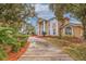 Impressive two-story house with a long driveway and lush landscaping at 6355 W Maclaurin Dr, Tampa, FL 33647