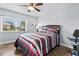 Spacious bedroom with striped bedding and wood floors at 6553 Grand Bahama Dr, Seminole, FL 33777