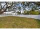 Backyard with a white fence and mature trees at 6701 E 19Th Ave, Tampa, FL 33619