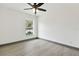 Bright bedroom featuring gray vinyl plank flooring and a ceiling fan at 6701 E 19Th Ave, Tampa, FL 33619