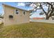 Tan house exterior with a backyard and white fence at 6701 E 19Th Ave, Tampa, FL 33619