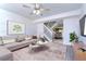 Spacious living room with a comfortable sofa and access to the dining area at 6781 121St Ave # F, Largo, FL 33773