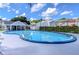 Community pool with surrounding patio and cabana at 6781 121St Ave # F, Largo, FL 33773