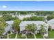 Aerial view of waterfront condos with lush landscaping and lake view at 7200 E Bank Dr, Tampa, FL 33617