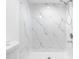 Clean shower with marble-style wall tile at 7200 E Bank Dr, Tampa, FL 33617