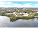 Aerial view of waterfront property with lush landscaping at 724 Bayshore Dr, Terra Ceia, FL 34250