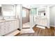 Spa-like bathroom with a walk-in shower and double vanity at 724 Bayshore Dr, Terra Ceia, FL 34250