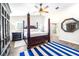 Main bedroom with a post bed, wood floors, and ensuite bathroom at 724 Bayshore Dr, Terra Ceia, FL 34250