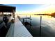 Sunset view of a waterfront property with a private dock and boat slip at 724 Bayshore Dr, Terra Ceia, FL 34250
