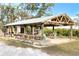 Open-air gazebo with benches and tables, ideal for relaxing outdoors at 724 Bayshore Dr, Terra Ceia, FL 34250