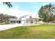 View of the house exterior and backyard with attached garage at 724 Bayshore Dr, Terra Ceia, FL 34250