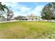 View of the house, large backyard and white fence at 724 Bayshore Dr, Terra Ceia, FL 34250