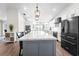Modern kitchen with large island, stainless steel appliances, and water view at 724 Bayshore Dr, Terra Ceia, FL 34250