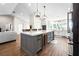 Modern kitchen with a large island, stainless steel appliances, and white cabinetry at 724 Bayshore Dr, Terra Ceia, FL 34250