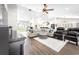 Open concept living room with hardwood floors, comfortable seating, and kitchen views at 724 Bayshore Dr, Terra Ceia, FL 34250