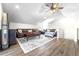 Bright living room featuring a large sectional sofa and wood floors at 724 Bayshore Dr, Terra Ceia, FL 34250