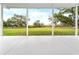 View from the porch shows a large backyard and trees at 724 Bayshore Dr, Terra Ceia, FL 34250