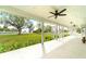 Spacious front porch overlooks a lush green lawn and water view at 724 Bayshore Dr, Terra Ceia, FL 34250