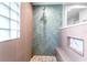 Walk in shower with herringbone tile and pebble floor at 724 Bayshore Dr, Terra Ceia, FL 34250