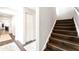 Modern staircase with dark wood risers and white walls at 724 Bayshore Dr, Terra Ceia, FL 34250