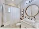 Modern bathroom with a white vanity and a large mirror at 7508 Parkshore Dr, Apollo Beach, FL 33572