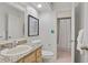 Powder room featuring a granite countertop, decorative mirror, and a shower/tub combo with curtain at 8701 Ballantrae Way, Tampa, FL 33647
