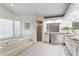 Bright bathroom featuring a soaking tub with glass block windows and an expansive vanity with double sinks at 8701 Ballantrae Way, Tampa, FL 33647