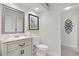 Powder room featuring a decorative mirror, granite countertop, and neutral paint at 8701 Ballantrae Way, Tampa, FL 33647