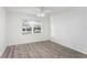 Bedroom with wood-look floors, a ceiling fan, neutral paint, and a window with blinds at 8701 Ballantrae Way, Tampa, FL 33647