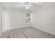 Clean and bright bedroom with wood-look floors, a ceiling fan, and a sunny window at 8701 Ballantrae Way, Tampa, FL 33647